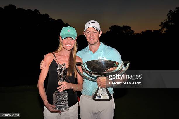 Rory McIlroy of Northern Ireland poses alongside his girlfriend Erica Stoll and the FedExCup and TOUR Championship trophies after his victory over...