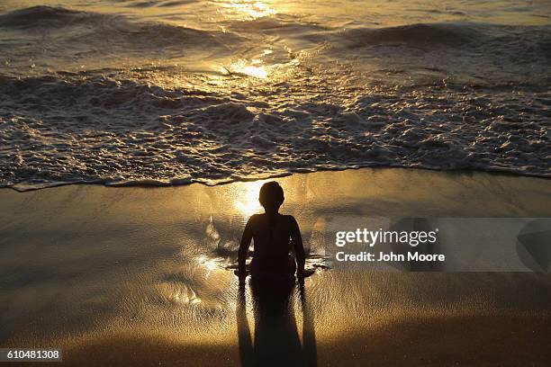 Child plays in the Pacific surf near the U.S.-Mexico border fence on September 25, 2016 in Tijuana, Mexico. The nearby Friendship Park is one of the...