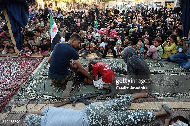 Syrian people perform a theatre play on a stage, which is set at the city centre after the cleansing of Daesh, in Jarabulus, Syria on September 25,...