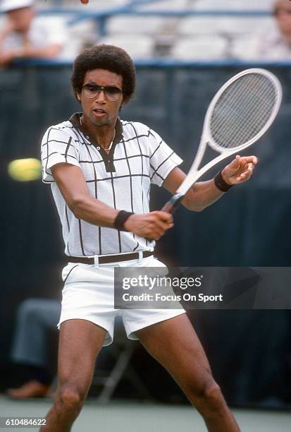 Arthur Ashe of the United States returns a shot during a match at the Men's 1978 US Open Tennis Championships circa 1978 at National Tennis Center in...