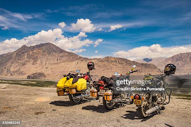 the motorcycles are parking beside diskit monastery in leh ladakh, jammu and kashmir, india - indian royal enfield stock pictures, royalty-free photos & images