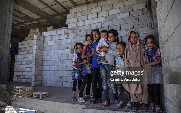 Family, who lived wealthily before the war in Syria's Kobani, take shelter at a construction in Jarabulus after the cleansing of Daesh, in Jarabulus,...