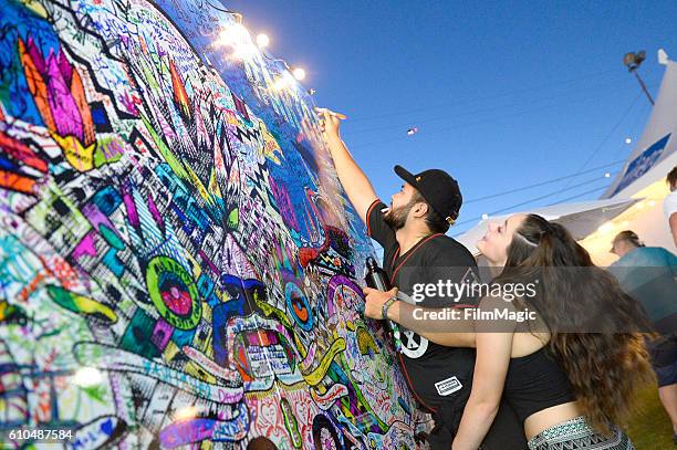 Festival goer adds to the art wall during day 3 of the 2016 Life Is Beautiful festival on September 25, 2016 in Las Vegas, Nevada.