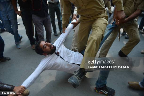 Indian police try to detain supporters of Jammu and Kashmir lawmaker Sheikh Engineer during a march towards the United Nations Military Observer...