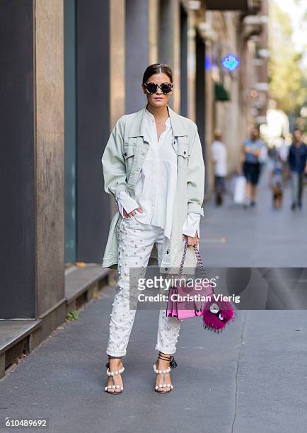 Nina Schwichtenberg wearing a 5 Preview jacket, white blouse and pants and pink Gucci bag outside Dolce & Gabbana during Milan Fashion Week...