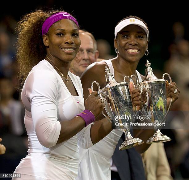 Serena Williams and Venus Williams of the USA celebrate with their winners' trophies after their Ladies Doubles final against Andrea Hlavackova and...