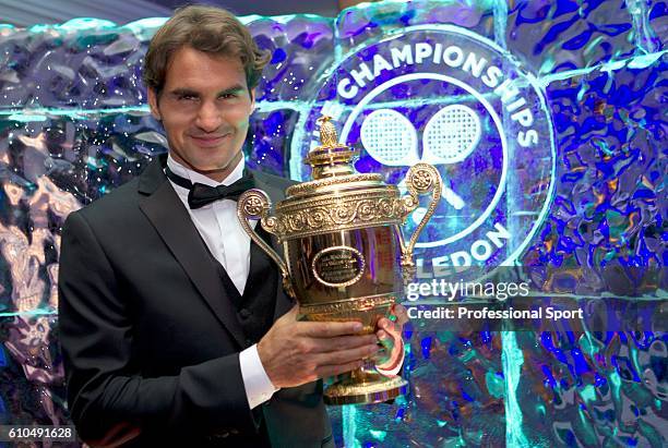 Wimbledon Singles Champion Roger Federer of Switzerland poses with the trophy during the Wimbledon Championships 2012 Winners' Ball at the...