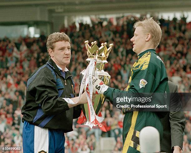 Steve Bruce and Peter Schmeichel of Manchester United holding the premiership trophy after winning the 1995/96 title after the FA Carling Premiership...
