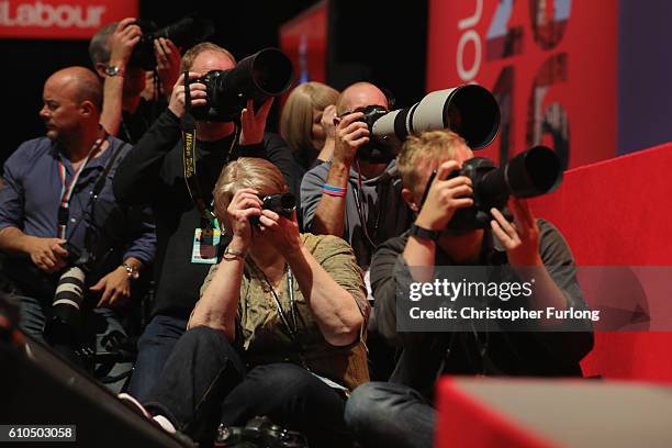 Press photographers capture images of Shadow Chancellor John McDonnell as he delivers his keynote speech to the Labour Party Conference on September...