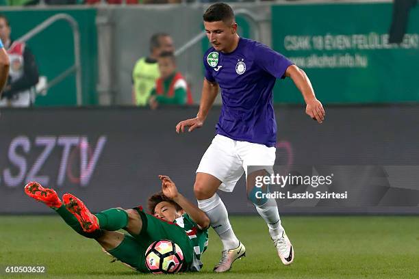 Seung-Woo Ryu of Ferencvarosi TC lies on the ground next to Enis Bardhi of Ujpest FC during the Hungarian OTP Bank Liga match between Ferencvarosi TC...