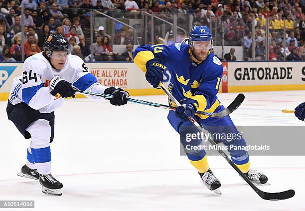 Mikael Granlund of Team Finland battles for position with Mattias Ekholm of Team Sweden during the World Cup of Hockey 2016 at Air Canada Centre on...