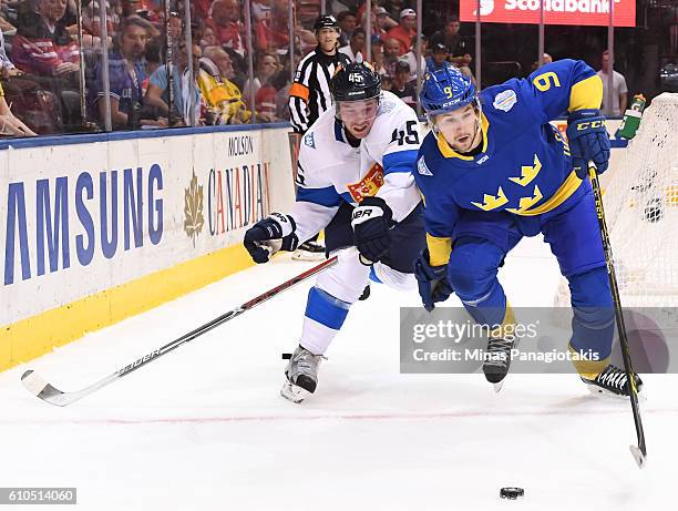 Sami Vatanen of Team Finland battles for a loose puck with Filip Forsberg of Team Sweden during the World Cup of Hockey 2016 at Air Canada Centre on...