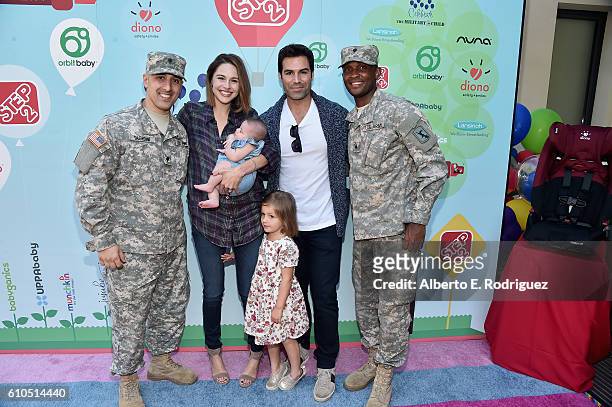 Actress Kaitlin Riley and actor Jordi Vilasuso pose with members of the U.S. Army National Guard at the Step2 & Favored.by Present The 5th Annual Red...