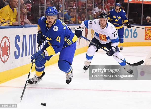 Niklas Hjalmarsson of Team Sweden chases down a loose puck with Leo Komarov of Team Finland chasing during the World Cup of Hockey 2016 at Air Canada...