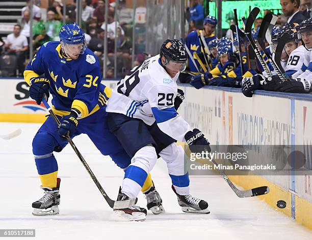 Patrik Laine of Team Finland battles for the puck along the boards with Carl Soderberg of Team Sweden during the World Cup of Hockey 2016 at Air...