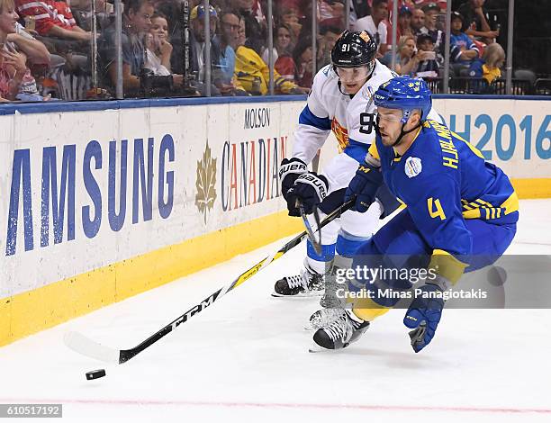 Niklas Hjalmarsson of Team Sweden pulls the puck away from Aleksander Barkov of Team Finland during the World Cup of Hockey 2016 at Air Canada Centre...
