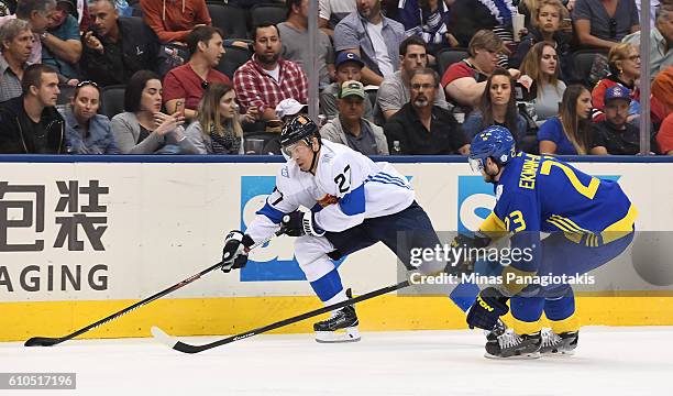 Joonas Donskoi of Team Finland stickhandles the puck against Oliver Ekman-Larsson of Team Sweden during the World Cup of Hockey 2016 at Air Canada...