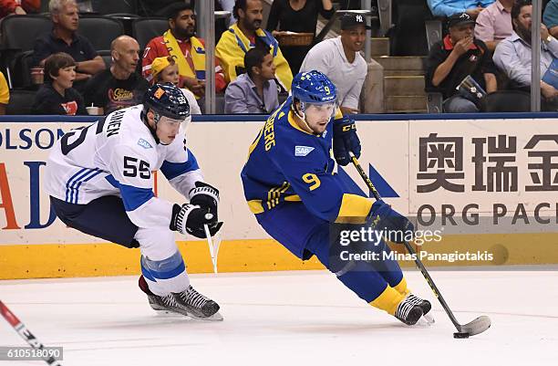 Filip Forsberg of Team Sweden stickhandles the puck away from Rasmus Ristolainen of Team Finland during the World Cup of Hockey 2016 at Air Canada...