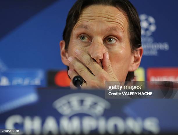 Bayer Leverkusen's football club head coach Roger Schmidt gestures as he gives a press conference on the eve of the UEFA Champions League football...