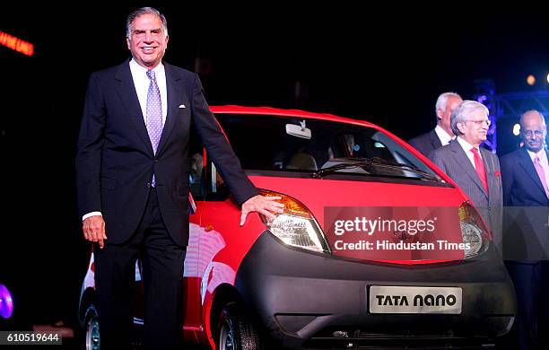 Tata Sons Chairman - Ratan Tata poses alongside the Tata Nano at its launch in Mumbai on Monday.