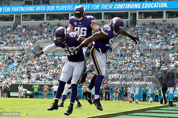 Emmanuel Lamur, Brian Robison and Danielle Hunter of the Minnesota Vikings celebrate after a safetly against the Carolina Panthers during the game at...