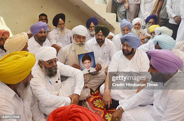 Punjab Congress President Captain Amarinder Singh with party leaders condoling the family members of deceased Robinjit Singh, student, who were...