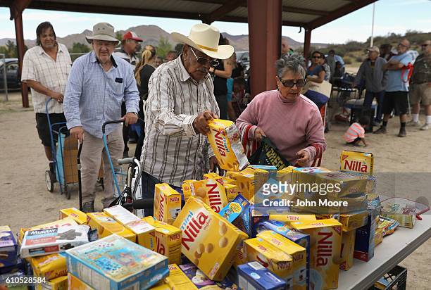 Residents line up to receive free food at mobile food pantry near the U.S.-Mexico border on September 26, 2016 in Jacamba Hot Springs, California....