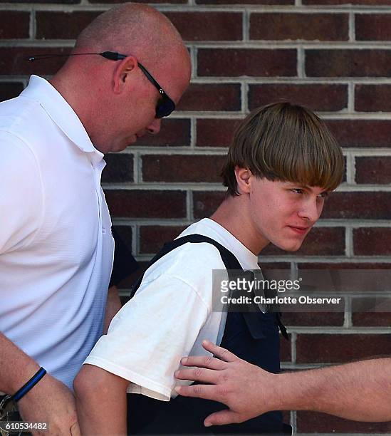 Charleston shooting suspect Dylann Roof is escorted from the Shelby Police Dept. Thursday, June 18, 2015 in Shelby, N.C. Jury selection is underway...