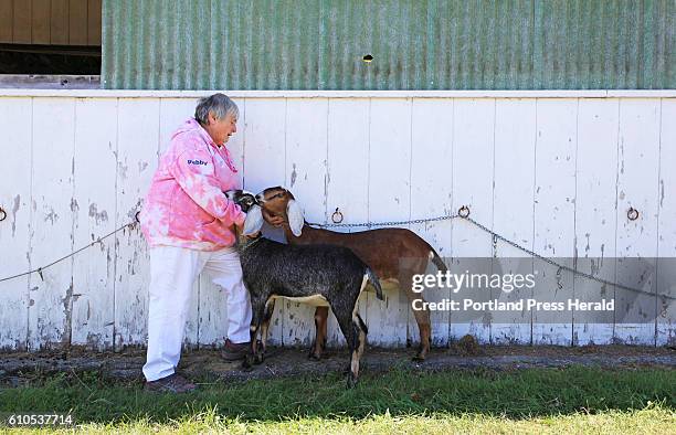 Debby Orff of Waldoboro comforts Gael and Gayleen, two Nubain goats owned by Phil Cassette of Saco, after Gail broke free from her collar after being...