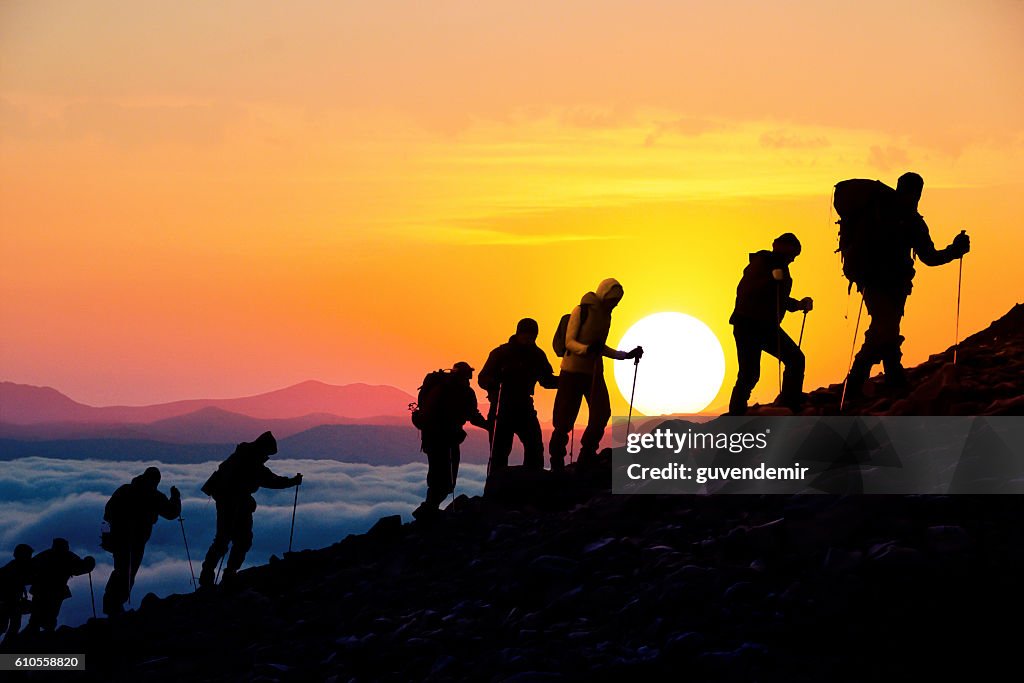 Silhouettes of hikers At Sunset