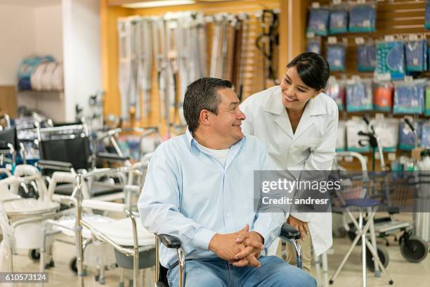 orthopedist helping disabled man - orthopedie stockfoto's en -beelden