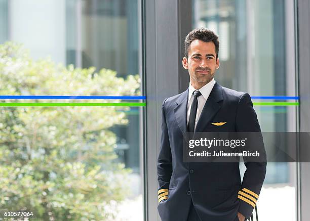 airline pilot in airport terminal - crew stock pictures, royalty-free photos & images