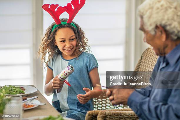 opening christmas crackers - christmas children stock pictures, royalty-free photos & images