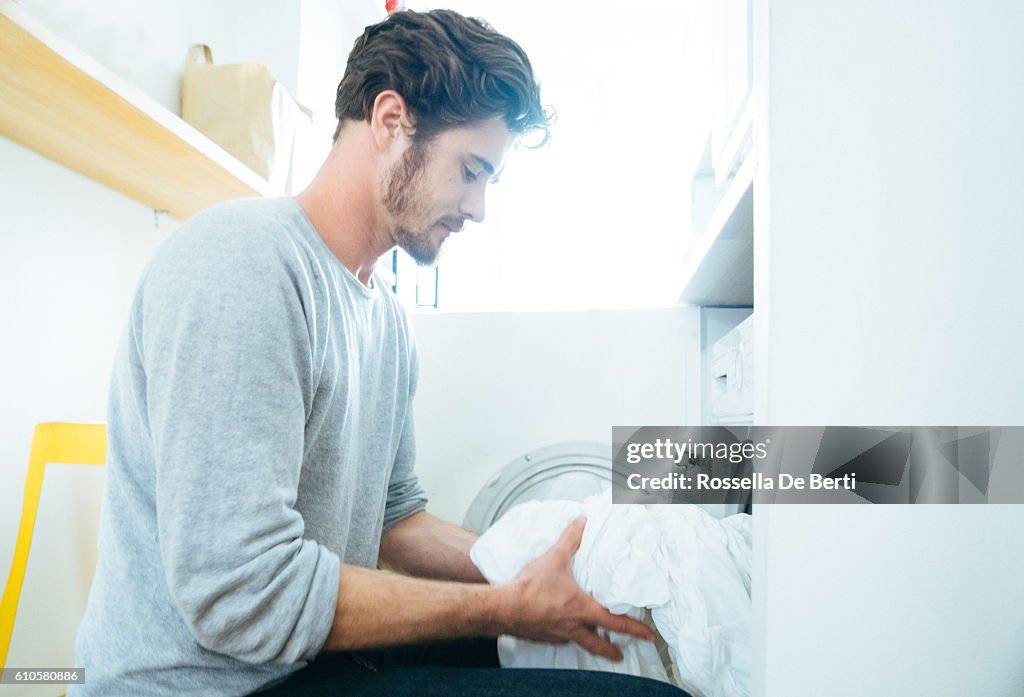 Man At Home Doing Laundry