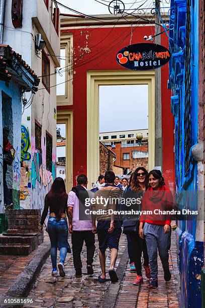 bogotá, colombia - the gateway that leads to the chorro de quevedo at the narrowest end of the colorful, cobblestoned calle del embudo, in the historic la candelaria - embudo stock pictures, royalty-free photos & images