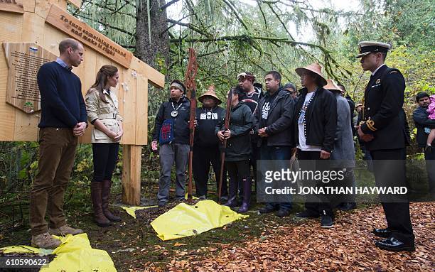 Prince William and Catherine, the Duke and Duchess of Cambridge look on after removing a rain jacket to unveil a plaque in the Great Bear rainforest...