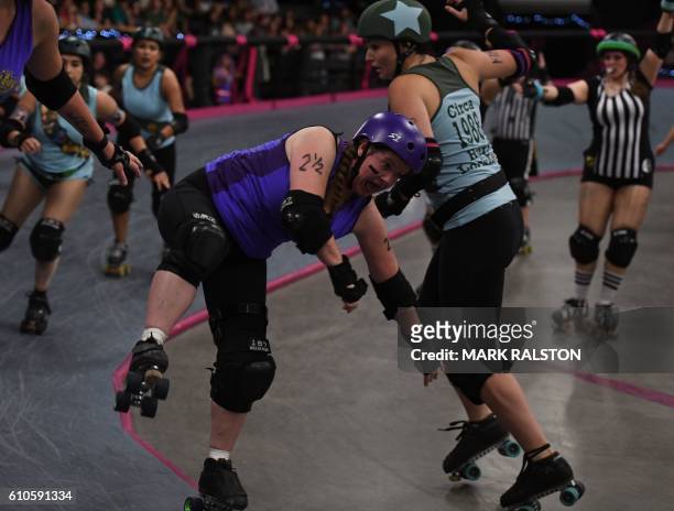 Members of the Varsity Brawlers team compete against the Tough Cookies team during the L.A. Derby Dolls women's banked track roller derby event in...