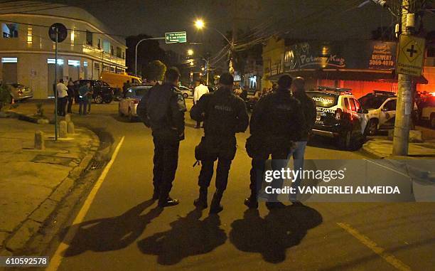 Rio's PM militarized police personnel guard the crime scene where Marcos Vieira de Souza, aka "Falcon" PM lieutnant, president of the Portela samba...