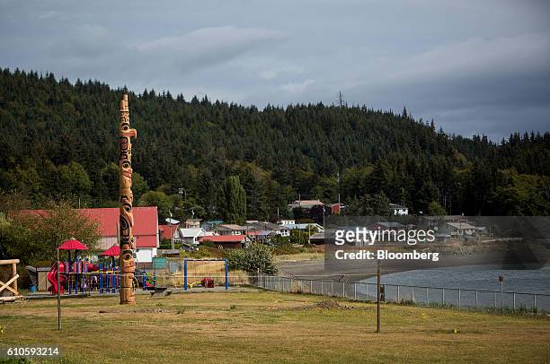 Totem pole stands in the First Nations village of Skidegate on the island of Haida Gwaii, British Columbia, Canada, on Friday, Aug. 26, 2016. Facing...