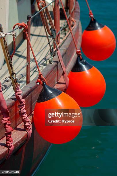europe, greece, view of red boat protection bumpers - parachoques fotografías e imágenes de stock