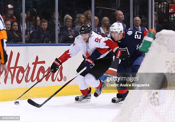 Steven Stamkos of Team Canada stickhandles the puck away from Ryan McDonagh of Team USA during the World Cup of Hockey 2016 at Air Canada Centre on...