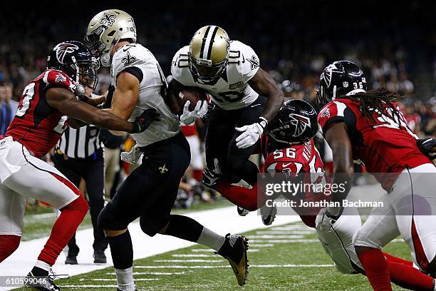 Brandin Cooks of the New Orleans Saints is tackled by Sean Weatherspoon of the Atlanta Falcons during the first half of a game at the Mercedes-Benz...