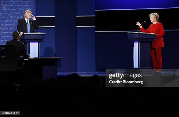 Donald Trump, 2016 Republican presidential nominee, listens as Hillary Clinton, 2016 Democratic presidential nominee, speaks during the first U.S....