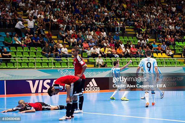 Santiago Basile of Argentina celebrates with his teammates Damian Stazzone and Cristian Borruto after scoring his team's third goal during the FIFA...