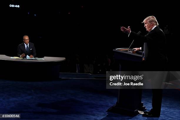 Republican presidential nominee Donald Trump speaks as Moderator Lester Holt looks on during the Presidential Debate at Hofstra University on...