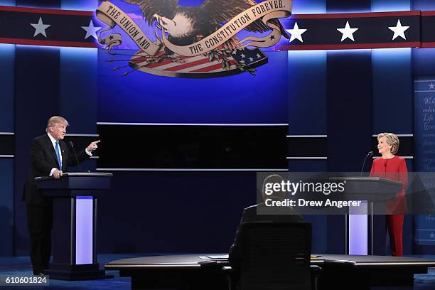 Republican presidential nominee Donald Trump speaks as Democratic presidential nominee Hillary Clinton and Moderator Lester Holt listen during the...