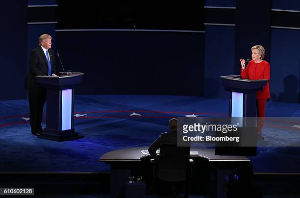 Donald Trump, 2016 Republican presidential nominee, listens as Hillary Clinton, 2016 Democratic presidential nominee, speaks during the first U.S....