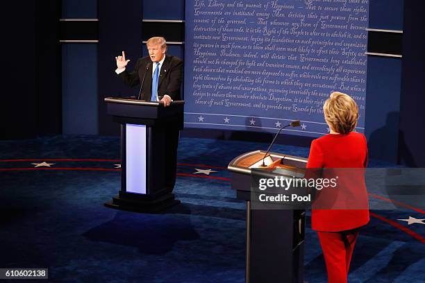 Republican presidential nominee Donald Trump speaks as Democratic presidential nominee Hillary Clinton listens during the Presidential Debate at...