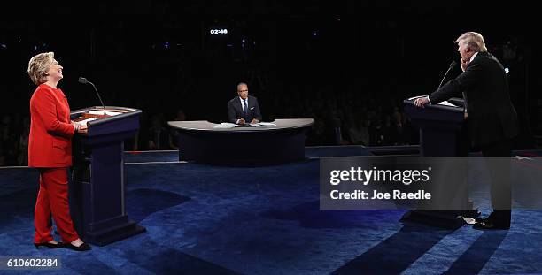 Republican presidential nominee Donald Trump speaks as Democratic presidential nominee Hillary Clinton and Moderator Lester Holt listen during the...