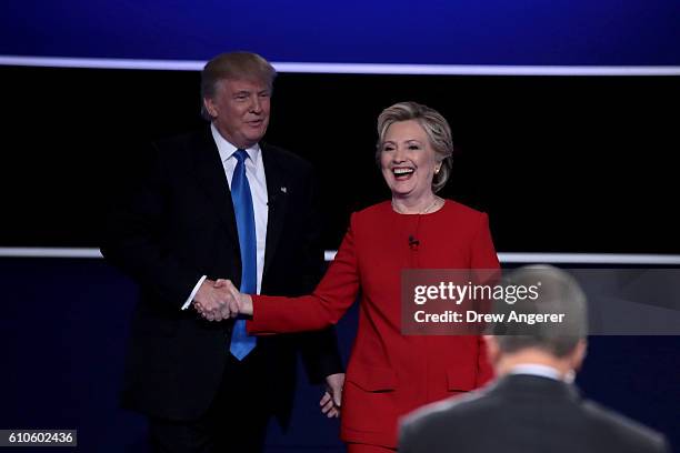 Republican presidential nominee Donald Trump and Democratic presidential nominee Hillary Clinton shake hands after the Presidential Debate at Hofstra...